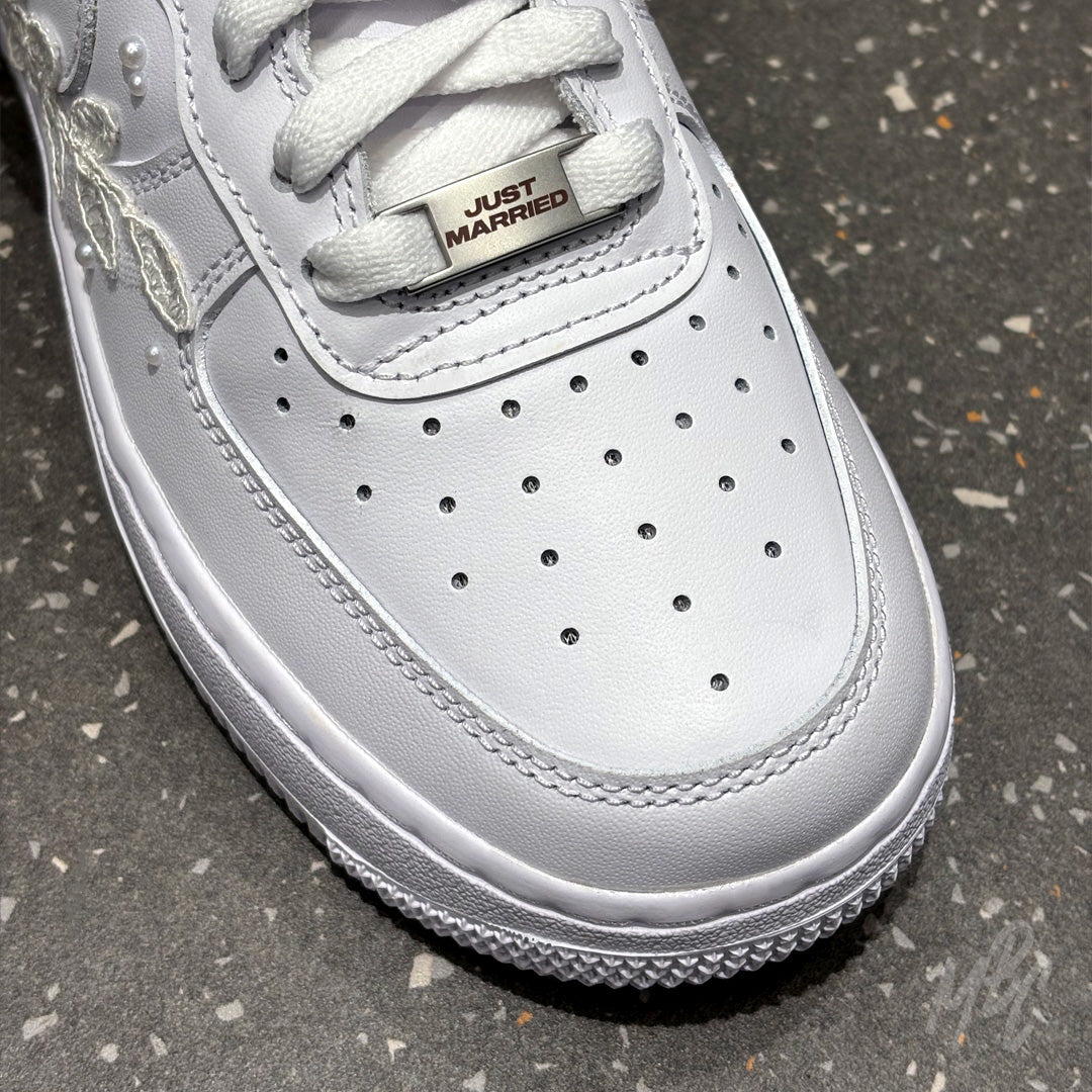 Close-up of white Air Force 1 toe box with custom Just Married lace lock and premium leather finish