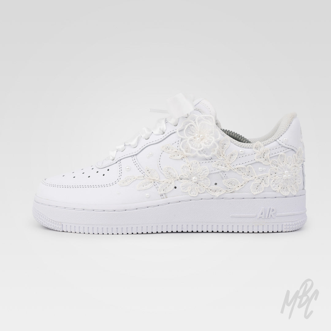Side view of white Air Force 1 custom with lace floral overlays and custom date detail on heel
