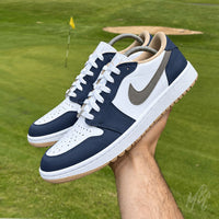 Custom Jordan golf shoes Midnight Tour Air Jordan 1 Low Golf with navy overlays, white base and grey swoosh detail on golf course