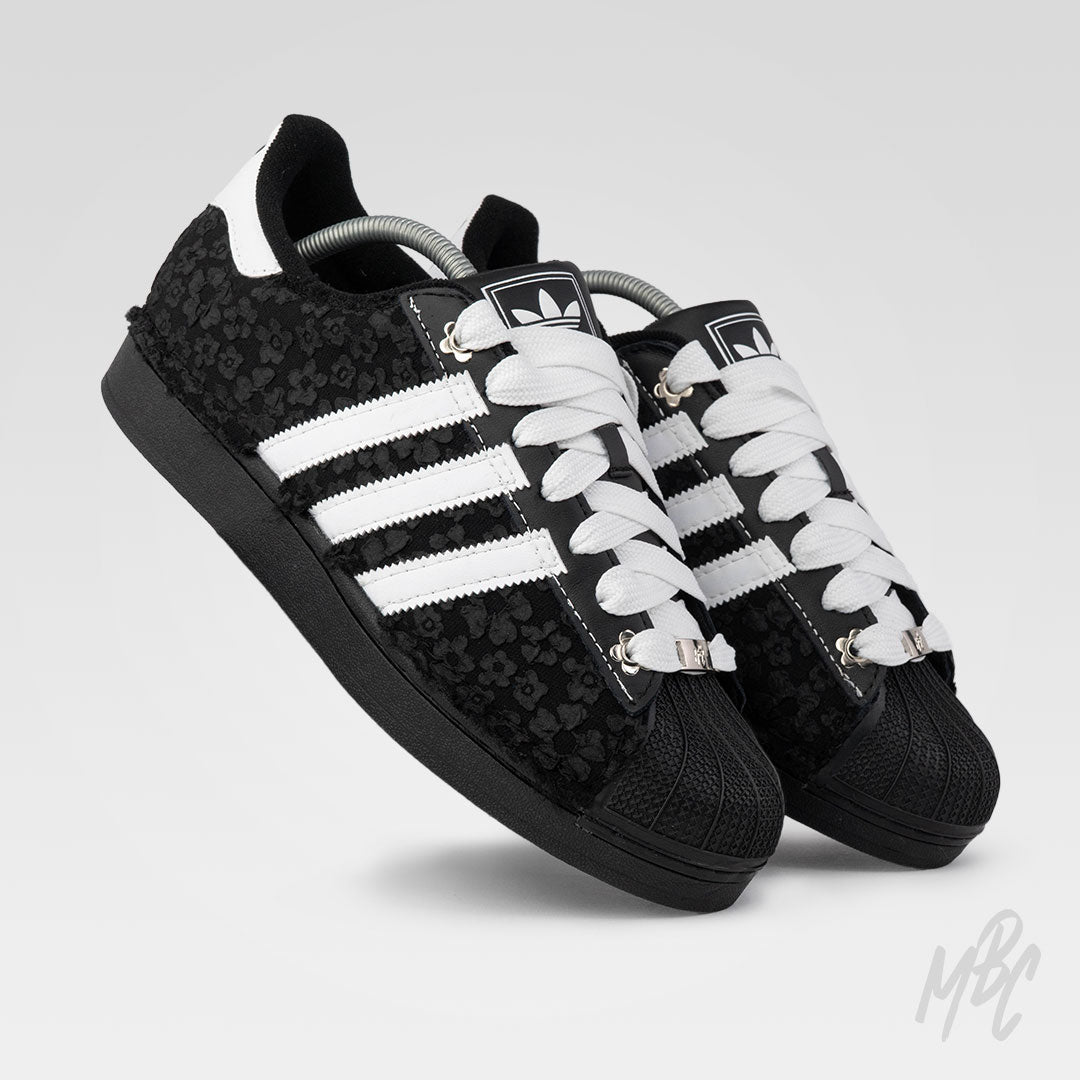 Black and white Adidas Superstar custom sneakers with a textured floral design 