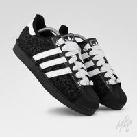 Black and white Adidas Superstar custom sneakers with a textured floral design 