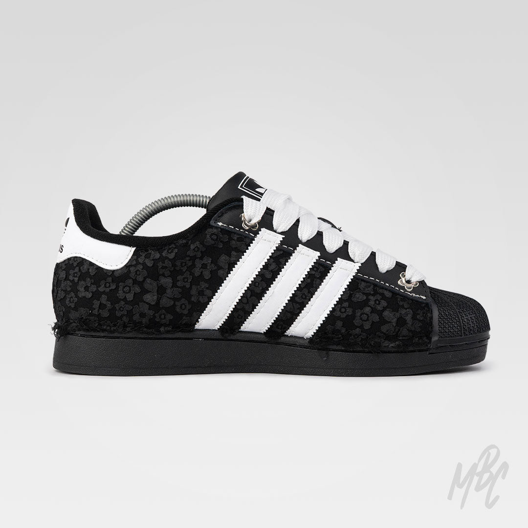 Black and white Adidas Superstar custom sneakers with a textured floral design 