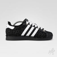Black and white Adidas Superstar custom sneakers with a textured floral design 