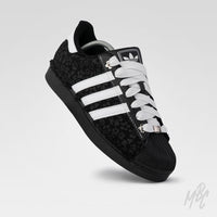 Black and white Adidas Superstar custom sneakers with a textured floral design 