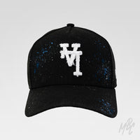 Midnight Canvas custom New Era cap with distressed white embroidered LA logo, hand-painted blue paint splatters and subtle faded detailing on a black baseball cap.