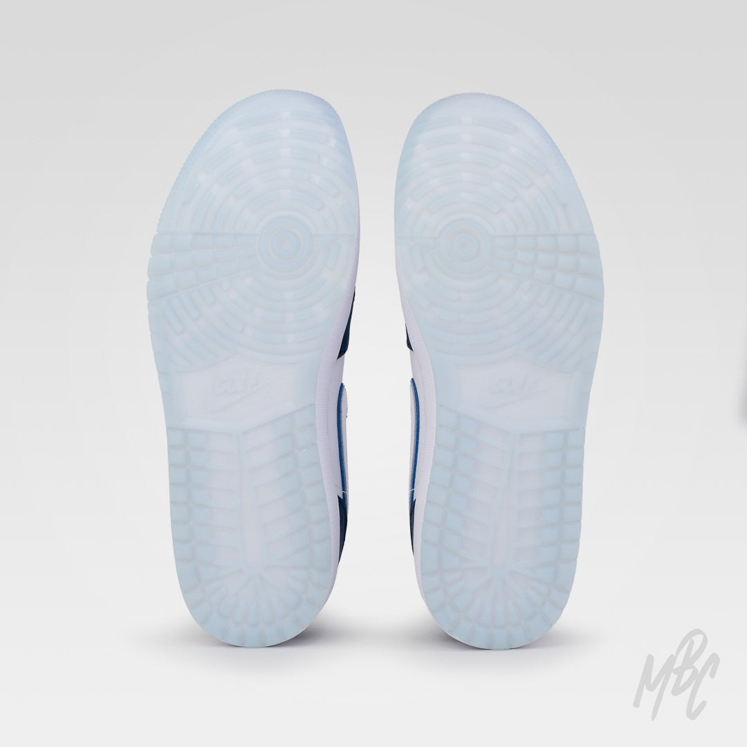Navy Suede Jordan 1 Low Golf outsole view showing translucent blue golf traction sole for grip and stability on the course