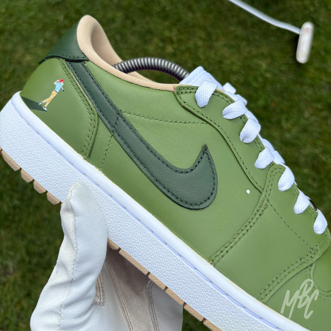 Close-up of Nike Air Jordan 1 Low Golf Off The Tee custom golf shoe with green colourway and golfer illustration detail