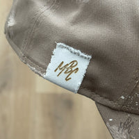 Side detail of custom New Era cap showing stitched MattB Customs label and distressed finish