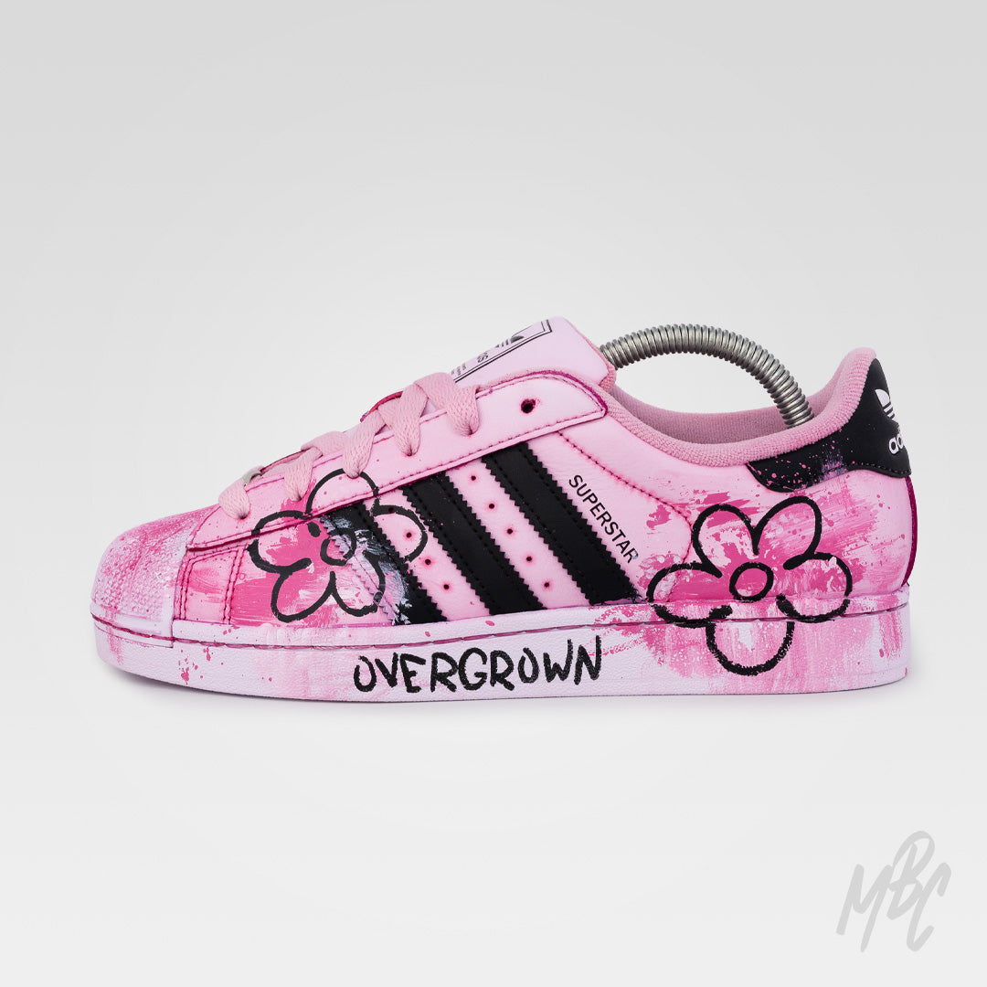 Outer side view of Pink Overgrown custom Adidas Superstar featuring hand-painted floral artwork, textured pink paint and Overgrown branding.