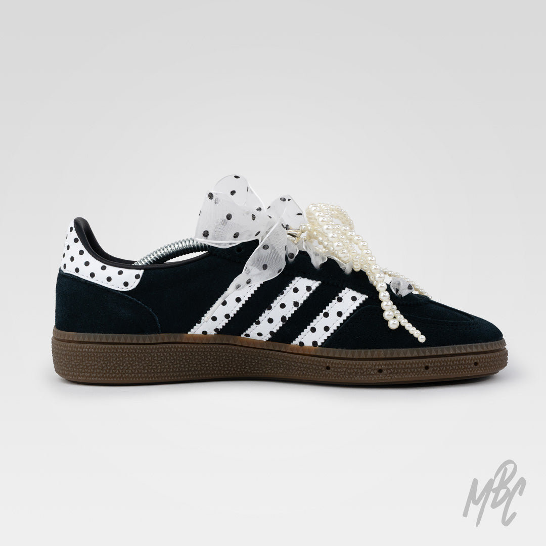 Adidas Spezial custom sneaker with polka dot detailing, pearl laces and sheer ribbon bow on black suede upper