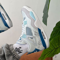 Custom Military Blue Jordan 4 Renaissance worn on foot with angel artwork and premium finish