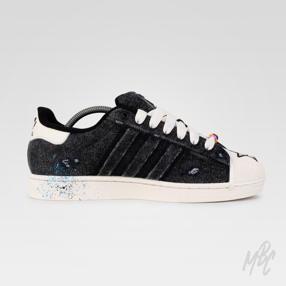 Inside view of Stardust Denim custom Adidas Superstar featuring distressed black denim, blue paint splatter detailing and hand-painted finish.
