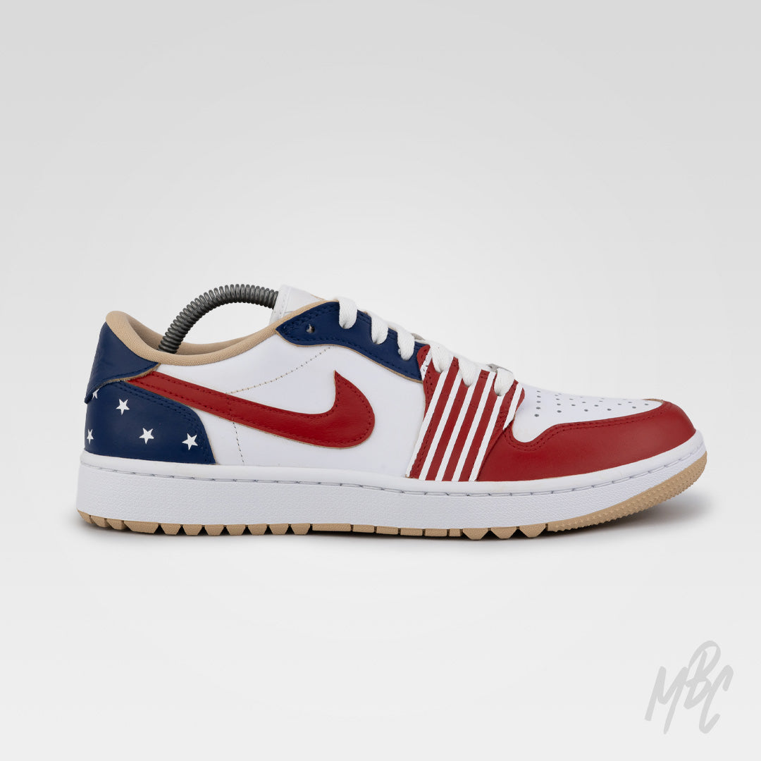 Close-up of Stateside Drive Jordan 1 Low Golf sneaker showing red leather Swoosh, blue star-print heel and striped custom detailing