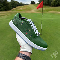 Sunday Club custom Jordan 1 Low Golf shoes photographed on a golf course, featuring hand-painted green leather, heat-pressed golfer illustrations and golf-inspired detailing.