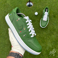Sunday Club custom Jordan 1 Low Golf shoes held above a putting green, featuring hand-painted green leather, heat-pressed golfer illustrations and a white golf ball in the background.