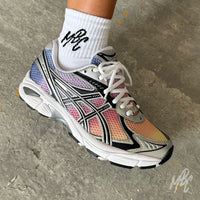 Close-up of the Sunset Dip Dye ASICS GT-2160 custom trainer highlighting the hand-painted yellow, orange, pink and purple gradient across the mesh upper with metallic ASICS overlays.