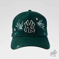 Twin Swallow New Era NY custom cap in green with embroidered swallow birds, metal star studs and paint splatter detail