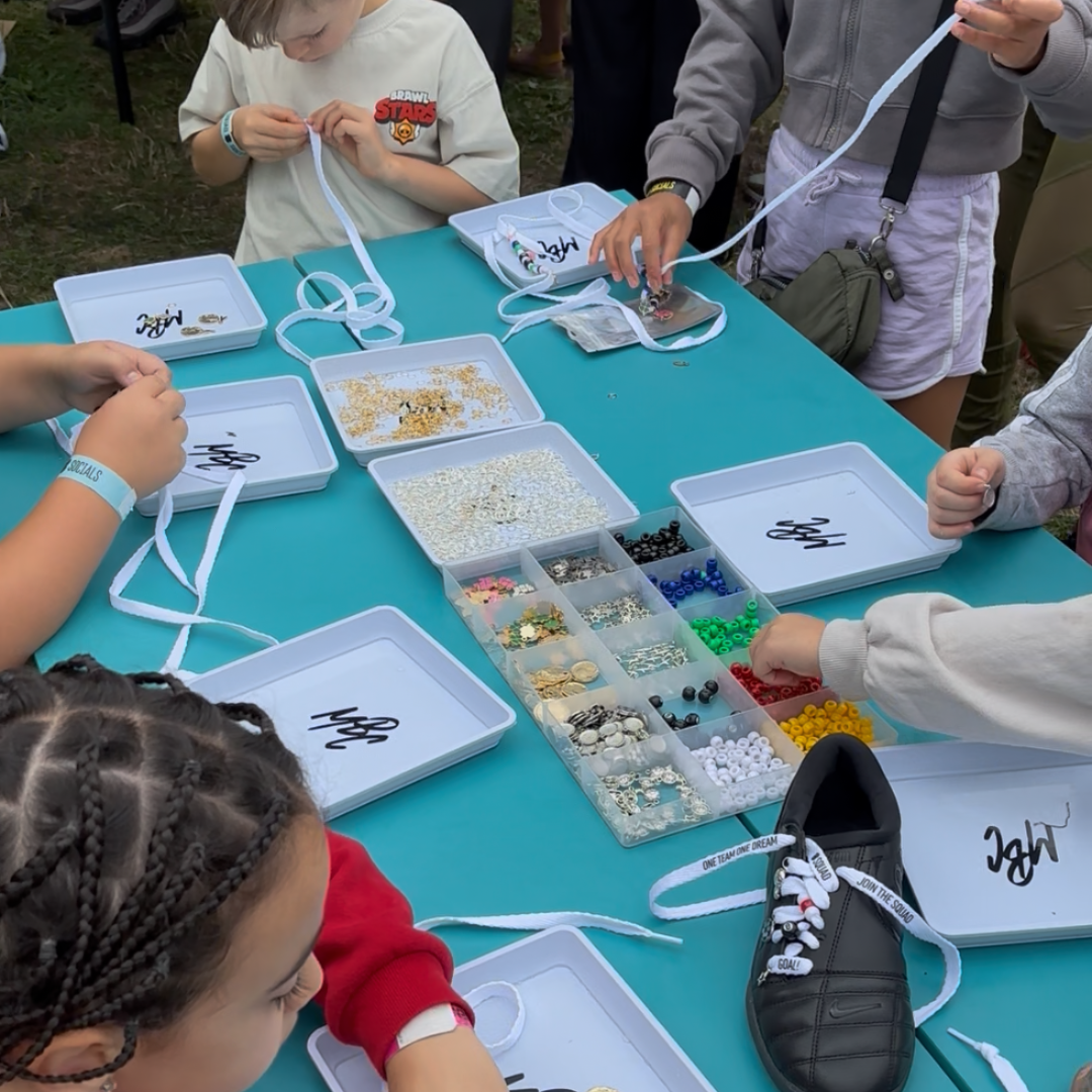 Lace and lace charm customisation workshop at the EE Squad Socials event geared to get young girl into football by hosting an event for the Womens Euros 2025 