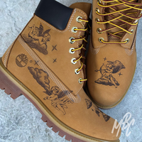 Custom Timberland 6 Inch boot with hand-engraved cherub and cloud artwork etched into the suede upper