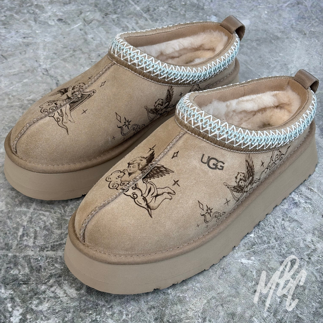 Pair of Heaven Etched UGG Tazz II customs with hand-drawn cherub designs engraved into suede panels