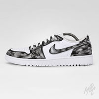 A Nike Air Jordan 1 Low sneaker in white leather with black brushstroke patterned overlays, shown in a side profile on a light gray background.