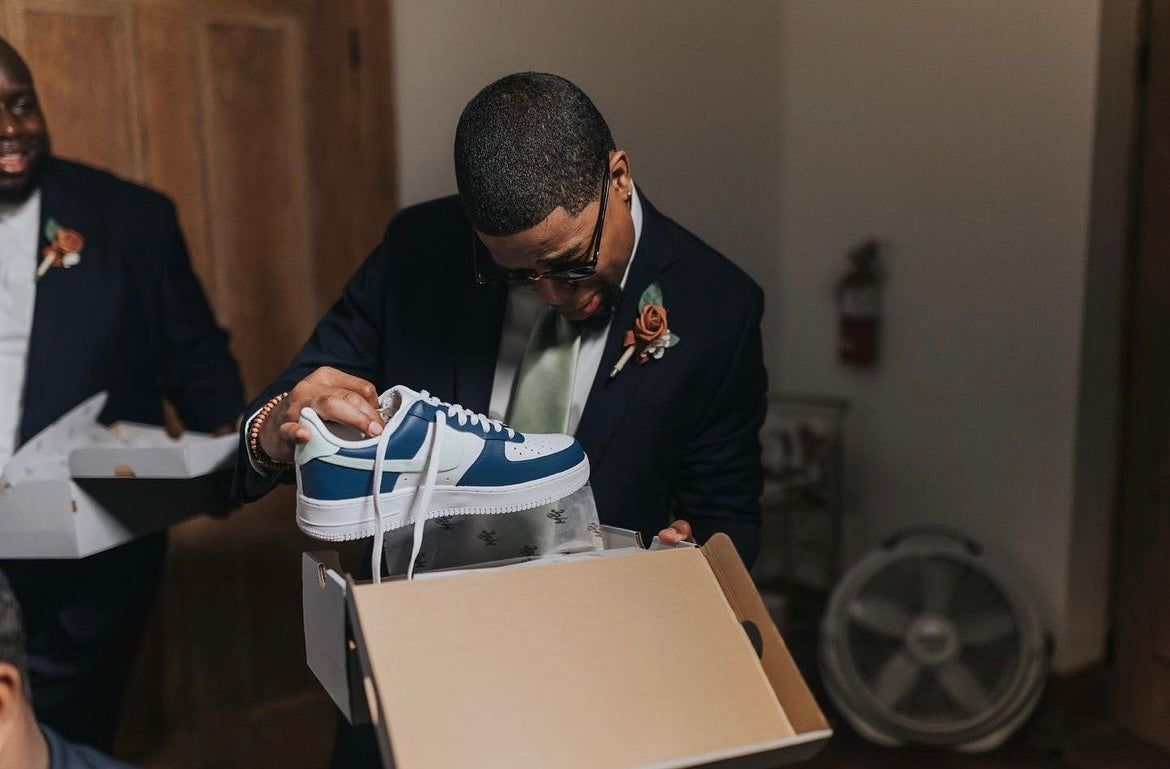 Groom's man reacting to a custom Jordan 1 low sneaker at a wedding