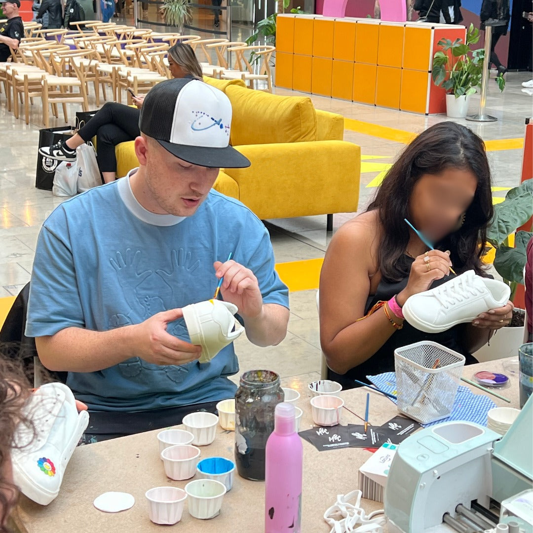 Matt painting a custom trainer at a workshop