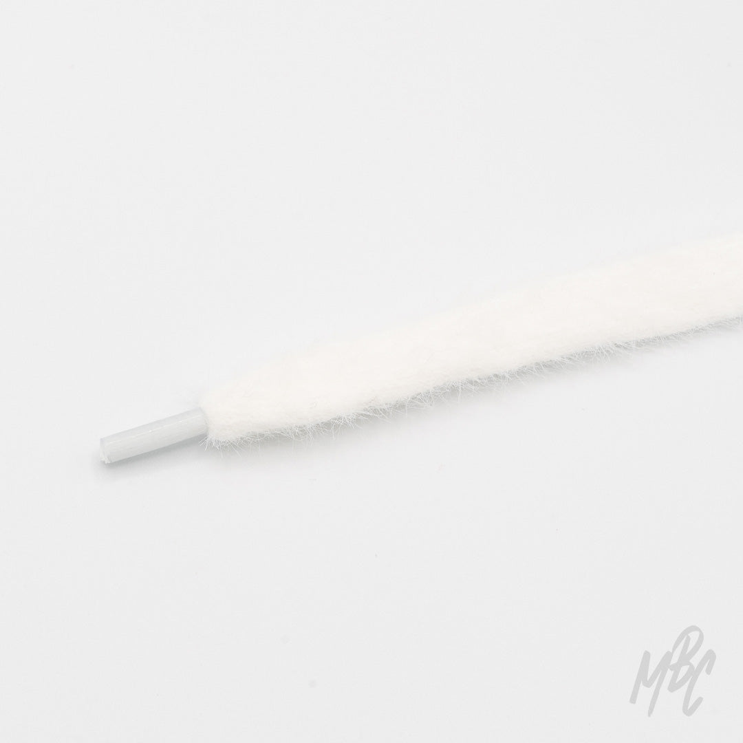 Close-up of a soft, fuzzy white cashmere shoelace with a clear plastic aglet on a white background.