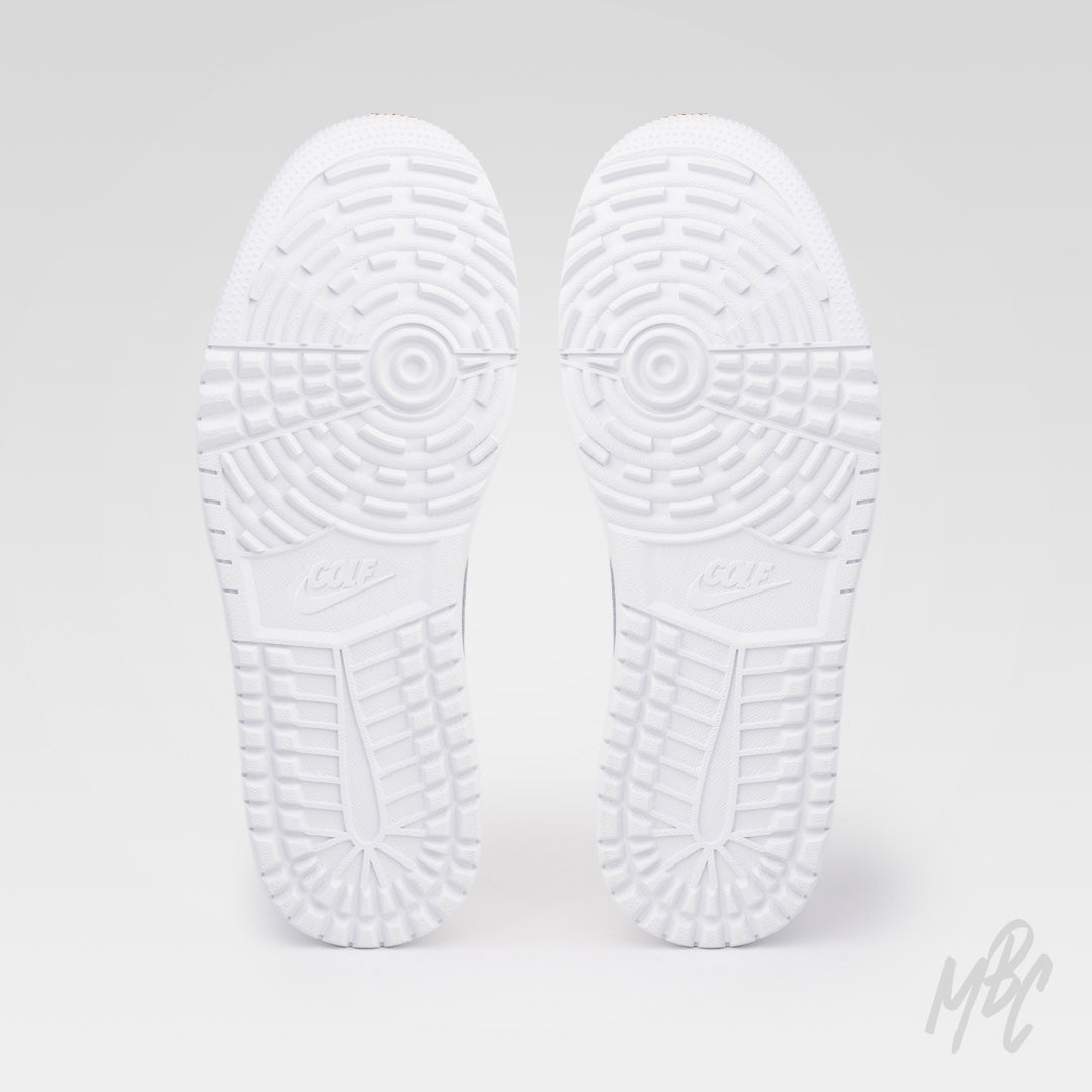 Pair of white golf shoe outsoles showing a detailed tread pattern with circular grip zones, deep grooves and raised traction sections.