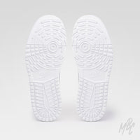 Pair of white golf shoe outsoles showing a detailed tread pattern with circular grip zones, deep grooves and raised traction sections.