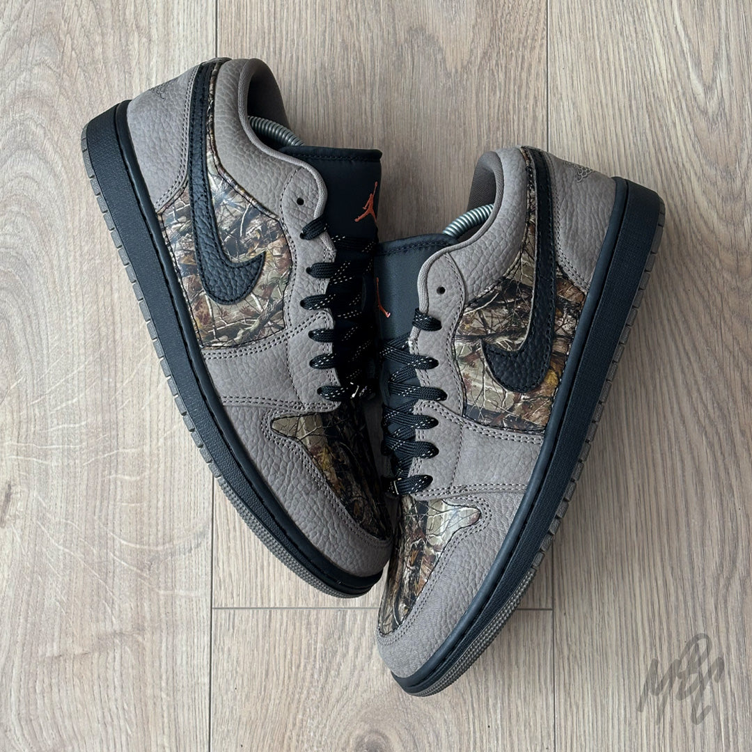 Woodland Camo Jordan 1 Low flat lay pair showing brown suede overlays and camo underlays