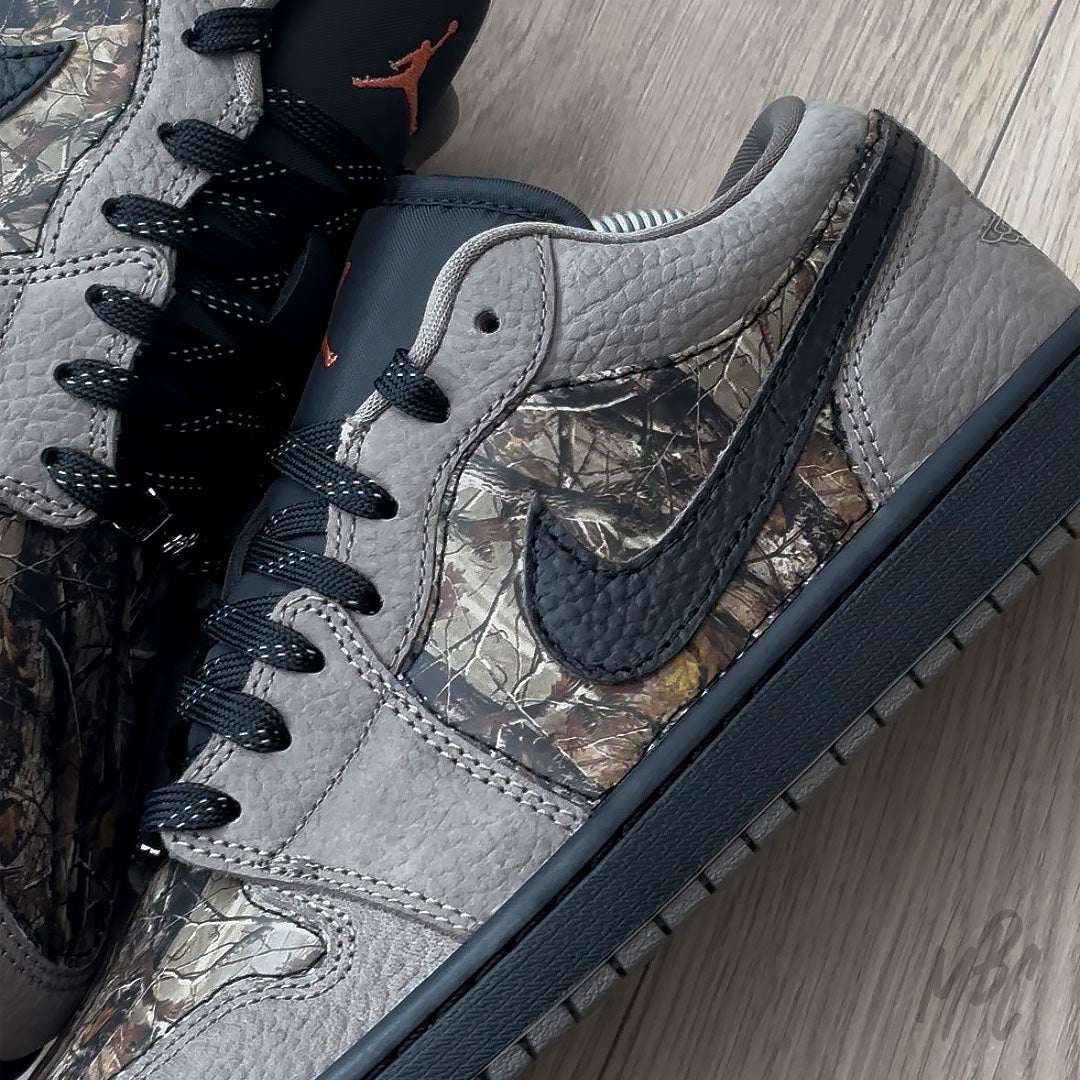Woodland Camo Jordan 1 Low close up of camo side panel and textured black leather swoosh