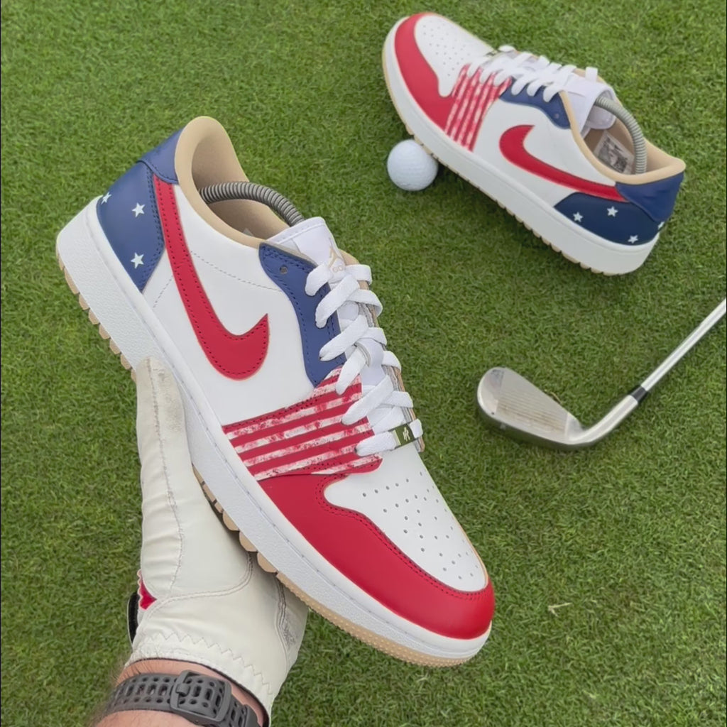 Stateside Drive custom Jordan 1 Low Golf shoes with hand-painted USA-inspired red, white and blue leather panels showcased on a golf course.