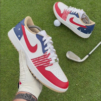 Stateside Drive custom Jordan 1 Low Golf shoes with hand-painted USA-inspired red, white and blue leather panels showcased on a golf course.