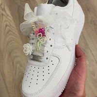 Video showcasing custom sneaker lace charms and lace accessories on Nike Air Force 1 trainers, featuring beaded floral lace charms, pearl details, ribbon laces and interchangeable lace decorations