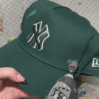 Handcrafted Twin Swallow custom New Era cap with embroidered bird design and studio customisation process