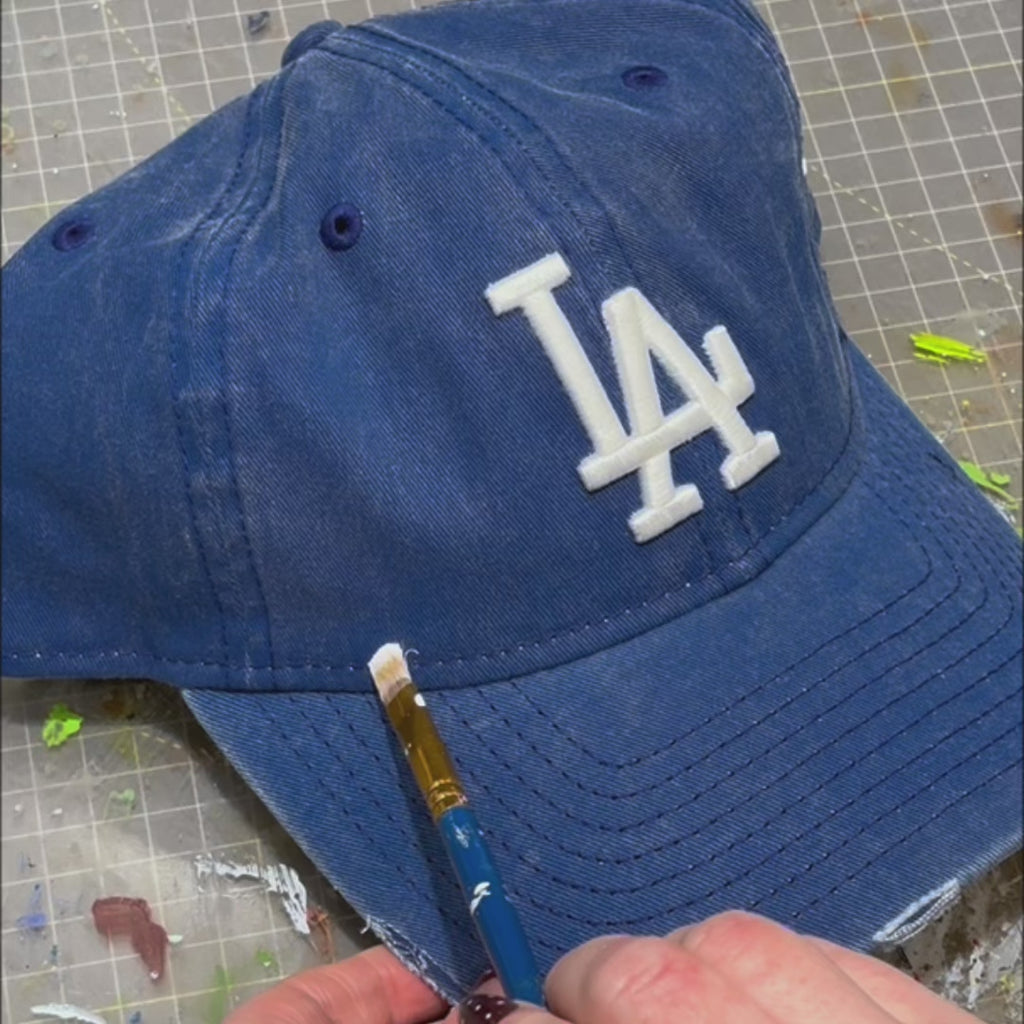 Video of hand customised New Era cap UK featuring denim finish, painted cloud design and custom distressing