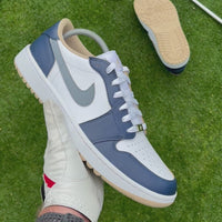 Midnight Tour custom Jordan 1 Low Golf shoes with hand-painted navy, grey and white leather panels showcased on a golf course.