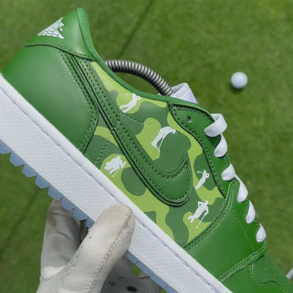 Lines of Play custom Jordan 1 Low Golf shoes featuring hand-painted golf course artwork showcased on a golf green.
