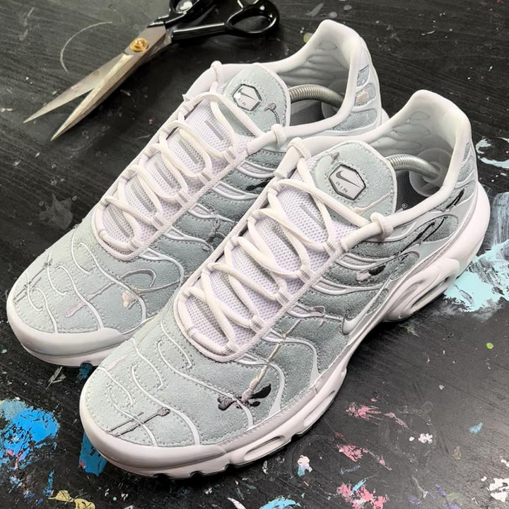 custom nike tns with powder blue suede with embroidered neutral paint splats created for a foot locker campaign